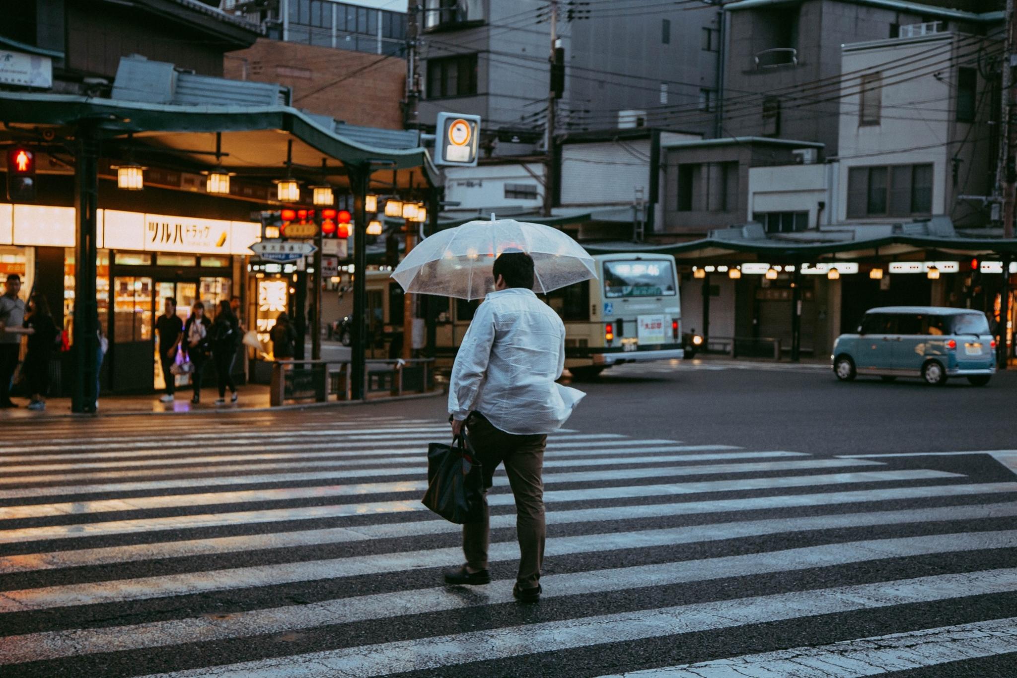 Walking man with an umbrella in Japan