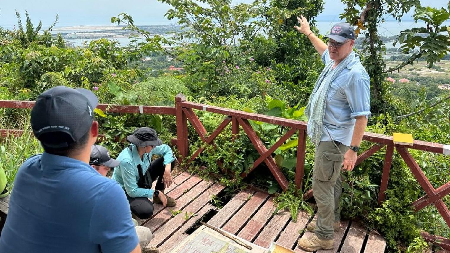 Associate Professor Garth Pratten discussing the strategic and operational significance of Brunei Bay to the Borneo campaign of 1945. The vantage point is the summit of Bukit Tempayan Pisang (722m), which was the site of a Japanese observation post prior to the Australian landings on 10 June 1945. 